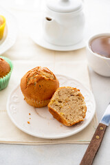 Homemade muffin with colorful paper cups, in a plate served with cup of tea