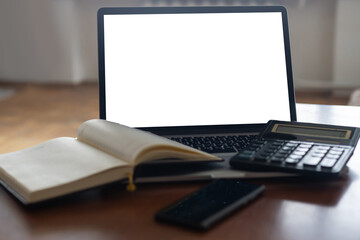 Workspace desk, calculator, Business image, Blank screen computer and supplies. laptop mock up screen view. work from home concept