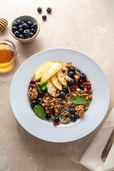 Healthy breakfast oatmeal porridge wit blueberries, cranberries, wallnuts and chia seeds. Dieting breakfast food