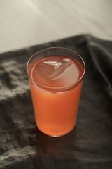 Guava drink in tumbler glass on linen cloth