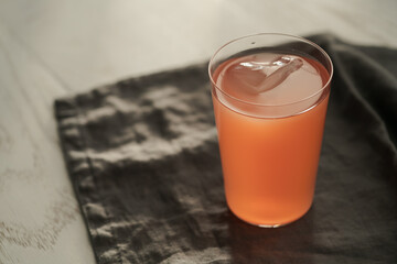 Guava drink in tumbler glass on linen cloth