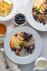 Healthy breakfast oatmeal porridge wit blueberries, cranberries, wallnuts and chia seeds. Dieting breakfast food