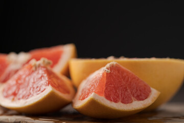 Sliced grapefruit on wood board closeup