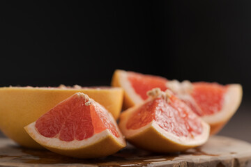 Naklejka na ściany i meble Sliced grapefruit on wood board closeup
