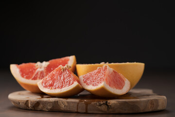 Sliced grapefruit on wood board closeup