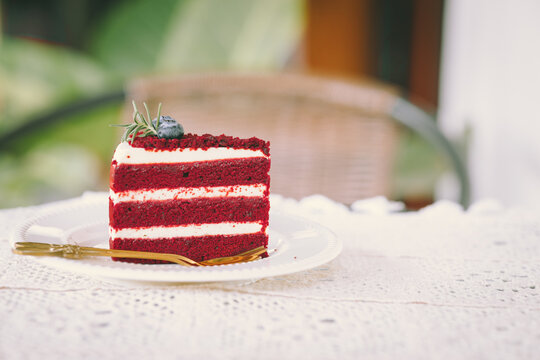 red velvet cream layer cake closeup on the cafe table, desser food sweet delicious vintage tone