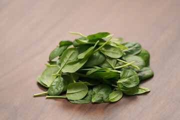 Fresh spinach leaves on walnut wood table