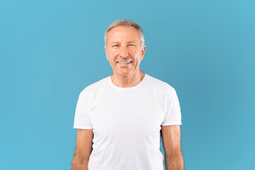 Portrait of happy mature man smiling posing at studio