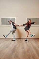 Fototapeta premium Lindy Hop teacher couple in a ballroom