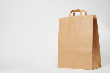 Brown paper bag on white background with copy space