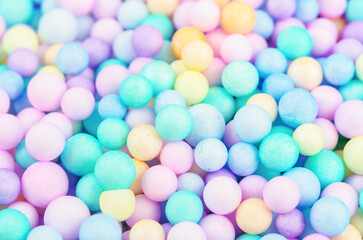 Foam beads of various colors brightly colored abstract background.