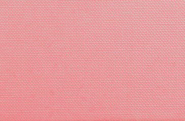 Pale pink or peach colored grunge effect paper wall texture background