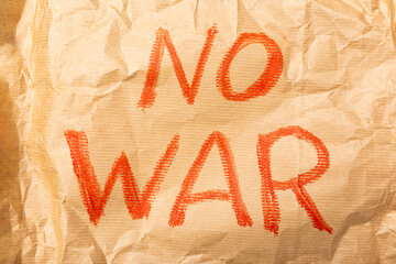 A call for peace and an end to the war on the craft paper. Close-up. No war. Stop war