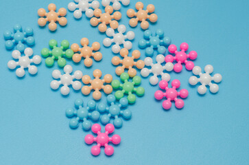multi-colored plastic snowflakes on a blue background