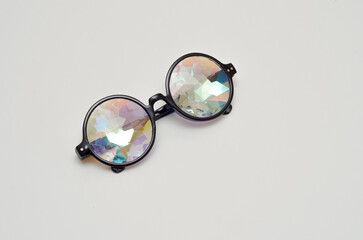 Fototapeta na wymiar designer kaleidoscope glasses on white background