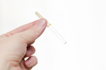 medical pipette in hand on a white background