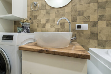 metal water tap with sink and faucet to turn on and regulate cold or hot water in expensive bathroom.