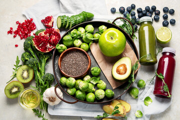 Assorted detox smoothie juices on light background.