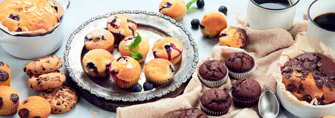 Muffins assortment on light background.