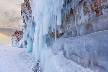 Blue ice cave grotto winter lake Baikal Russia. Frozen clear icicles, beautiful adventure landscape