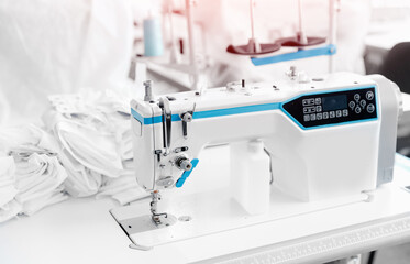 Closeup sewing machine with thread, background white color sun light. Concept Interior of garment factory
