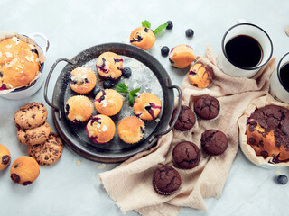 Muffins assortment on light background.