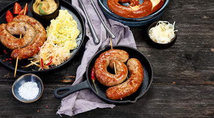 Grilled German sausages on wooden background.