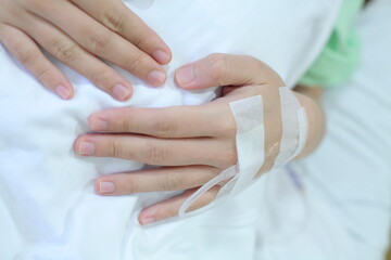 hand of a female patient giving saline