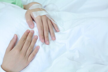 hand of a female patient giving saline