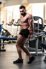 Fototapeta na wymiar Muscular Man Is Hitting Side Triceps Pose