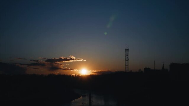 A beautiful sunset over the bridge and the river was filmed in the form of a timelapse. Cool shots of the city and nature