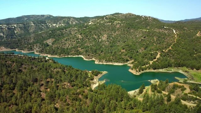 Blue lake in the Troodos mountains in the rays of the sun in the spring .Cyprus island. Aerial view.