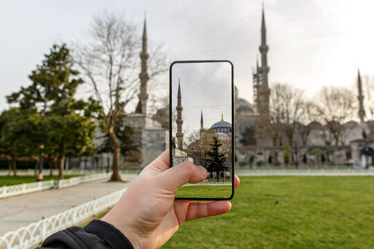 Taking photos of Istanbul, Turkey using a smartphone camera. Blue Mosque on the screen.
