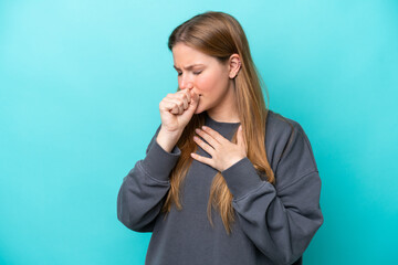 Young caucasian woman isolated on blue background coughing a lot
