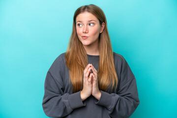 Young caucasian woman isolated on blue background scheming something