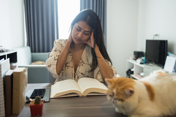Stressed woman read book and feel headache in house
