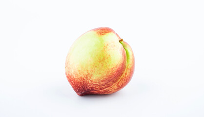 One fresh nectarine on a white background