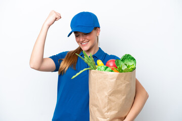 Fototapeta na wymiar Young delivery woman taking a bag of takeaway food isolated on white background celebrating a victory