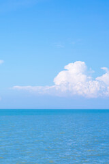Naklejka na ściany i meble Sea or ocean calm water with blue sky and white clouds.