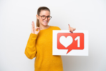 Young caucasian woman isolated on white background holding a placard with Like icon and celebrating a victory