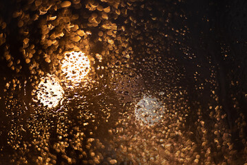 Blurred background with raindrops and lights.