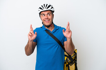 Young caucasian man with thermal backpack isolated on white background with fingers crossing