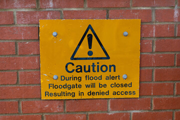 Warning sign informing the public that is a risk of a flood, the floodgate will be closed...