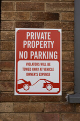 Private property no parking tow away zone sign informing the public of the risk of parking in this area