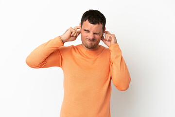 Brazilian man over isolated white background frustrated and covering ears