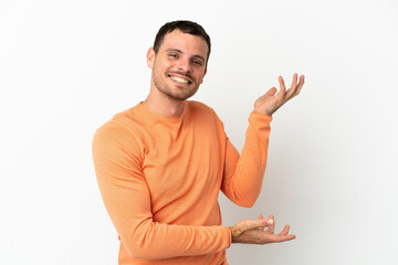 Brazilian man over isolated white background extending hands to the side for inviting to come