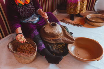 Woman making argan oil, Morocco. Holding seeds with her hands. Real people doing real things. Africa