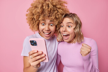 Pretty positive young womren stare happily at smartphone screen react on awesome news find out...
