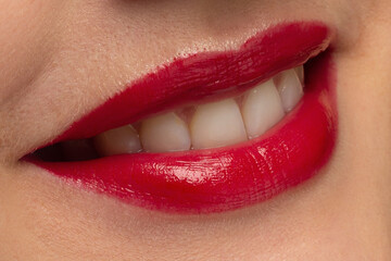 Obraz premium Perfect red lips makeup. Close up macro photo with beautiful female mouth. Plump full lips. Close-up face detail. Perfect clean skin, light fresh lip make-up. Beautiful spa tender lip