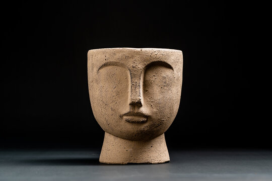 brown pot with a face on it